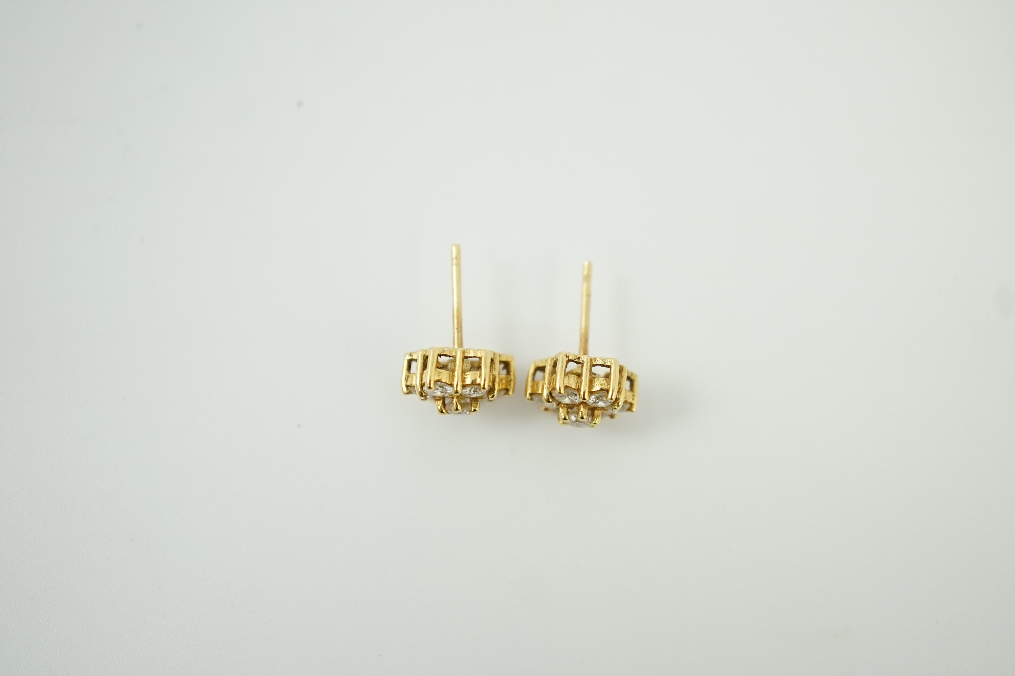 A pair of yellow metal and seven stone diamond cluster set ear studs, 7mm, gross weight 2.8 grams.